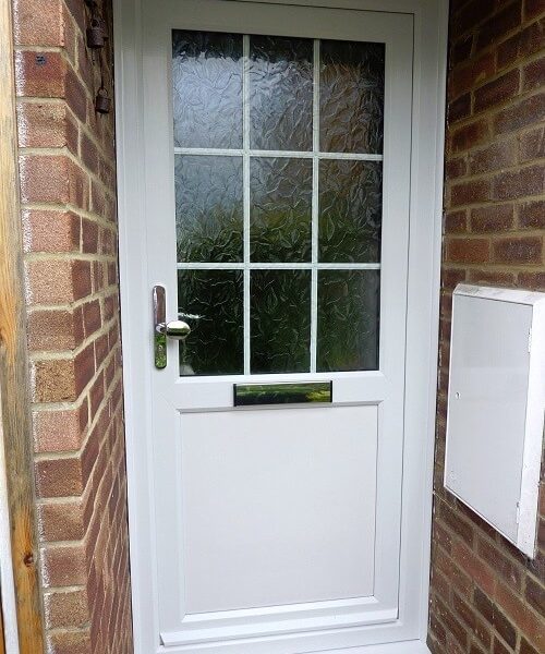 white front door with decorative glass